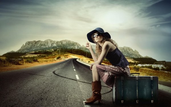 Девушка с чемоданом на дороге