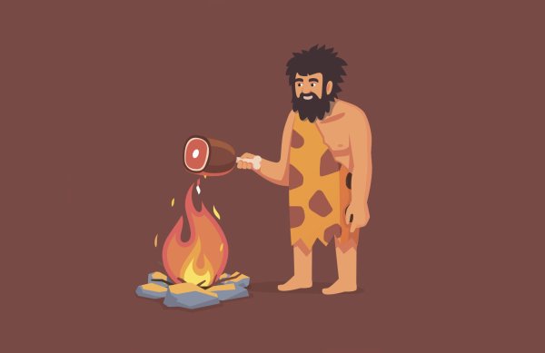 Первобытный человек готовит пищу на огне