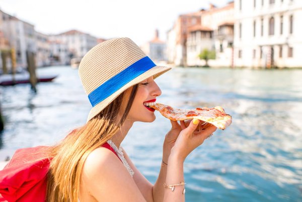 Люди едят пиццу в Италии