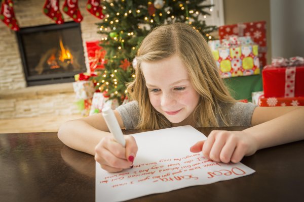 Девочка пишет письмо деду Морозу