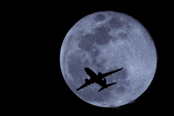 Самолет на фоне Луны высокого разрешения