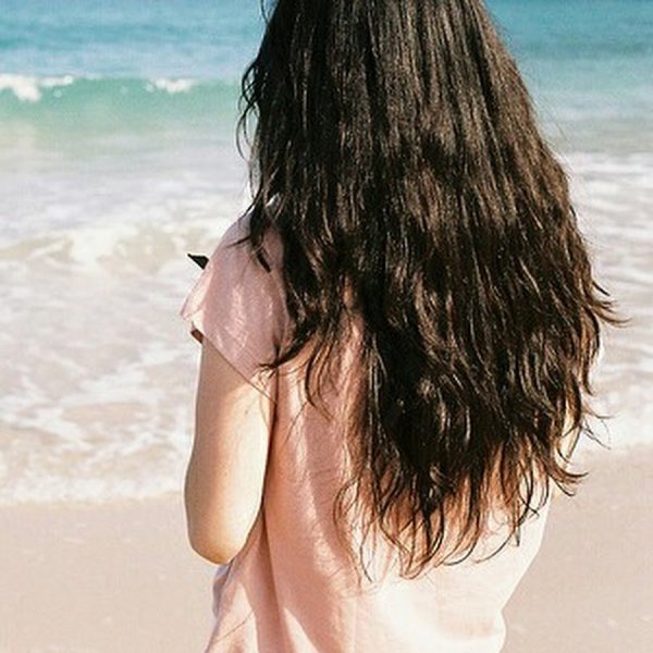 Брюнетка с длинными волосами на море