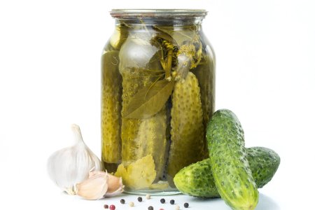Маринованные огурцы в банке на белом фоне